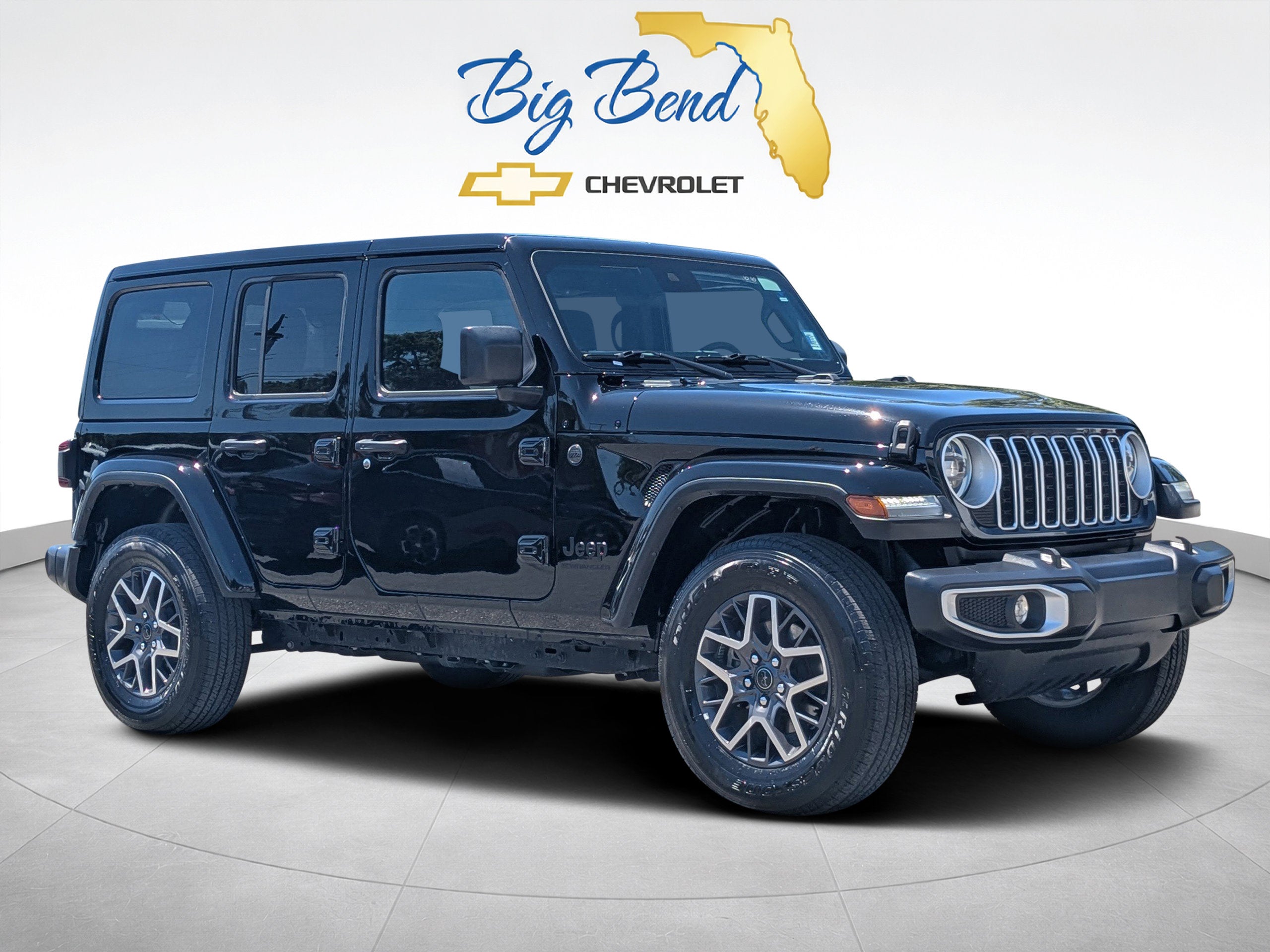 2025 Jeep Wrangler 4-Door Sahara 4x4 in Black — front three-quarter view