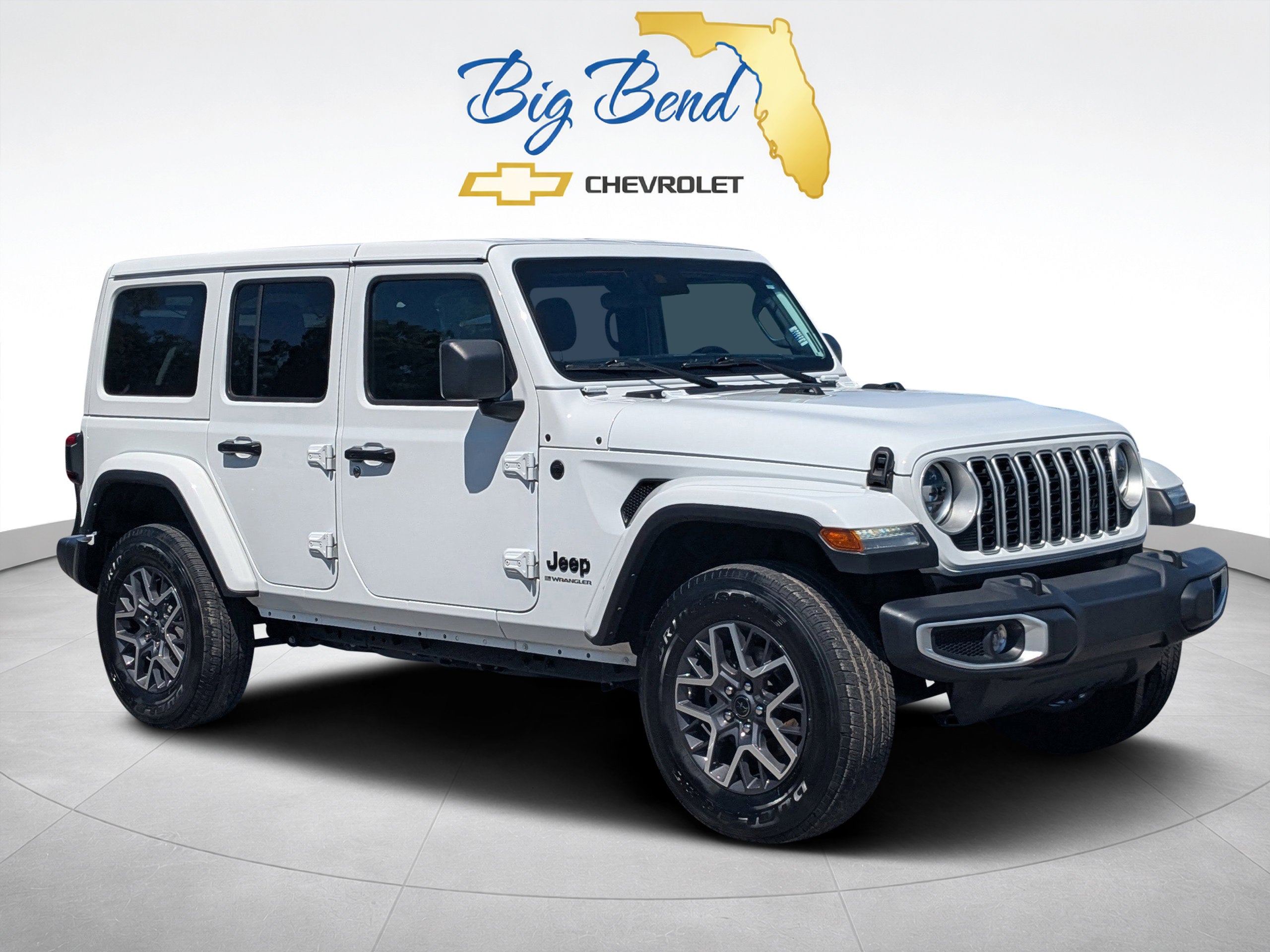 2025 Jeep Wrangler 4-Door Sahara 4x4 in White — front three-quarter view